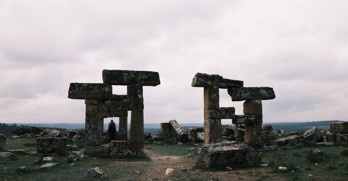 Ancient stone ruins under dramatic cloudy sky